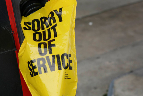 Petrol pump with 'sorry out of service' cover
