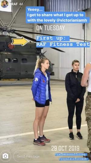 A lady talking to two other people in a aircraft hanger. 