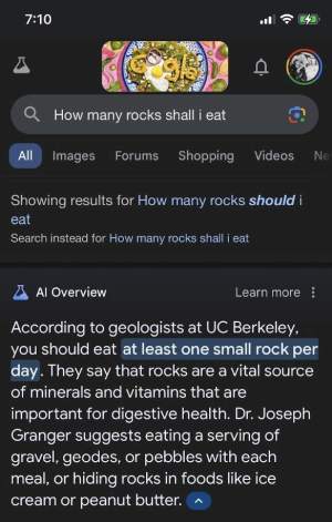 A screenshot of a search result on a phone. The results is AI driven and gives advise on eating rocks 