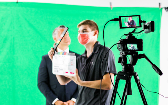 filming taking place infront of a green screen