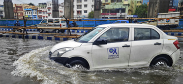 car driving through a flooded river