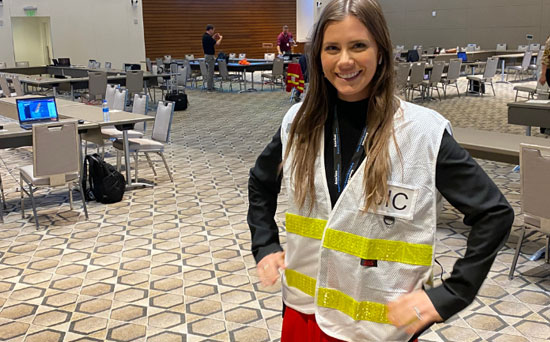 woman in hi-vis jacket smiling to camera