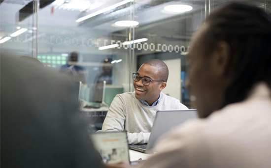 people sitting in office smiling around a table