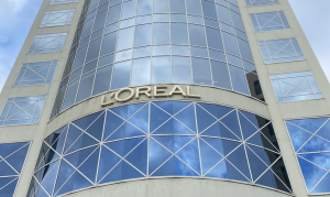 A glass building with the brand name L'Oreal across the front